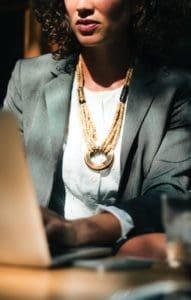 Image of a well dressed business woman on a laptop helping with SEO